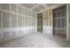Spacious room featuring unfinished drywall, with visible electrical outlets and door frames at 2301 N Ridgewood Ave, Tampa, FL 33602