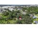 An aerial view of a property surrounded by lush greenery and mature trees in a quiet residential neighborhood at 2305 N 48Th St, Tampa, FL 33605