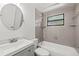 Updated bathroom with shower over tub, gray tiling, and modern fixtures at 2305 N 48Th St, Tampa, FL 33605