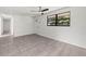 Bright living room with neutral walls, tile flooring, decorative front door and ceiling fan at 2305 N 48Th St, Tampa, FL 33605