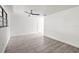 Bright living room featuring neutral walls, tile flooring, a ceiling fan, and a sun-filled window at 2305 N 48Th St, Tampa, FL 33605