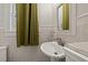 Bathroom featuring a pedestal sink and neutral tile at 2450 2Nd N Ave, St Petersburg, FL 33713