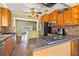 Inviting kitchen featuring wood cabinets, granite counters, and stainless steel appliances at 2450 2Nd N Ave, St Petersburg, FL 33713
