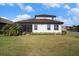 Well-maintained backyard showcasing the home's screened patio, lush lawn, and tidy landscaping at 2515 63Rd Ter E, Ellenton, FL 34222