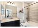 This bathroom has a tiled shower and tub combo, dark vanity, and granite counter top at 2515 63Rd Ter E, Ellenton, FL 34222
