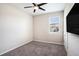 This bedroom has gray carpet, a ceiling fan and a window with a view of the outside at 2515 63Rd Ter E, Ellenton, FL 34222