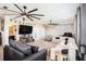 This room has gray carpet, neutral colored walls, a ceiling fan, bar area, and plenty of seating to relax at 2515 63Rd Ter E, Ellenton, FL 34222