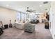 This room has gray carpet, neutral colored walls, ceiling fans, and furniture for relaxing and watching tv at 2515 63Rd Ter E, Ellenton, FL 34222