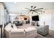 This room has gray carpet, neutral colored walls, a ceiling fan, a bar area, and furniture for relaxing and watching tv at 2515 63Rd Ter E, Ellenton, FL 34222