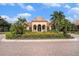 Elegant clubhouse exterior with beautiful landscaping, grand entrance, and stately palm trees at 2515 63Rd Ter E, Ellenton, FL 34222