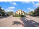 Elegant gated community entrance with lush landscaping and a secure entry system at 2515 63Rd Ter E, Ellenton, FL 34222