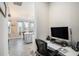 This home office is located near an open concept kitchen with tile floors and gray cabinets at 2515 63Rd Ter E, Ellenton, FL 34222