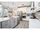 Modern kitchen with stainless steel appliances, white countertops, and gray cabinets at 2515 63Rd Ter E, Ellenton, FL 34222