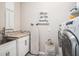 This laundry room has a washer, dryer, sink, countertop, and cabinets at 2515 63Rd Ter E, Ellenton, FL 34222