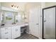 Bright bathroom featuring dual sinks, white cabinetry, and walk-in shower at 2515 63Rd Ter E, Ellenton, FL 34222
