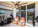 Inviting screened patio with comfortable chairs, ceiling fan, and outdoor grill for enjoyable outdoor living at 2515 63Rd Ter E, Ellenton, FL 34222