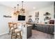 This Personal cave has an industrial style bar area with 3 stools, mini fridge, and decor at 2515 63Rd Ter E, Ellenton, FL 34222