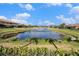 Picturesque view of a community pond with a fountain, surrounded by well-maintained landscaping and homes at 2515 63Rd Ter E, Ellenton, FL 34222