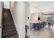 A stairway leads to an open concept kitchen and living area with modern light fixtures and an island with bar stool seating at 2515 63Rd Ter E, Ellenton, FL 34222