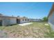 Backyard showcasing green grass, partial fence, concrete patio, and house exterior at 2614 E Liberty St, Tampa, FL 33612