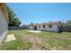 Spacious backyard featuring green grass, partial fence, and a concrete patio at 2614 E Liberty St, Tampa, FL 33612