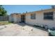 Concrete patio and block construction on this single Gathering home's backyard with metal grate on the door and windows at 2614 E Liberty St, Tampa, FL 33612