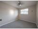Cozy bedroom with neutral paint, carpeted floors, and a ceiling fan at 2614 E Liberty St, Tampa, FL 33612