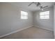 Neutral bedroom with carpeted floors, ceiling fan, and multiple windows at 2614 E Liberty St, Tampa, FL 33612