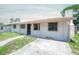 Charming single-story home featuring a cozy porch and concrete driveway at 2614 E Liberty St, Tampa, FL 33612