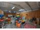 Cluttered garage interior with wood paneling, a corrugated metal ceiling, and fluorescent lighting at 2614 E Liberty St, Tampa, FL 33612