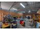Messy garage interior featuring plywood siding, a corrugated metal ceiling, and fluorescent lighting at 2614 E Liberty St, Tampa, FL 33612