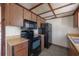 Kitchen featuring wood cabinetry and black appliances at 2614 E Liberty St, Tampa, FL 33612