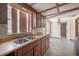 Traditional kitchen featuring wood cabinets, dual stainless steel sink, and a tiled floor at 2614 E Liberty St, Tampa, FL 33612