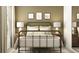 Comfortable bedroom with a metal bed frame, decorative pillows, and rustic wooden nightstands at 2711 Bryce Ravine Ave, Plant City, FL 33563