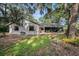 Well-maintained backyard featuring a screened-in porch and lush landscaping at 2838 Timber Knoll Dr, Valrico, FL 33596