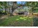 Spacious backyard with mature trees, a well-maintained lawn, and lush landscaping at 2838 Timber Knoll Dr, Valrico, FL 33596