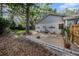 Cozy backyard featuring a gravel area with four chairs, trees, and a cactus at 2838 Timber Knoll Dr, Valrico, FL 33596