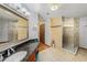 Well-designed bathroom featuring dual shower heads, large mirror and vanity with granite countertop at 2838 Timber Knoll Dr, Valrico, FL 33596
