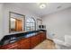 Bathroom featuring a long vanity with a black countertop, wood cabinets, and a large window at 2838 Timber Knoll Dr, Valrico, FL 33596