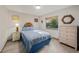 Bedroom features a full-sized bed, wood floors, and a window with a view of greenery at 2838 Timber Knoll Dr, Valrico, FL 33596