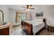 Bedroom features a full-sized bed, wood floors, and a window with a view of greenery at 2838 Timber Knoll Dr, Valrico, FL 33596