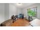 Bedroom with a neutral color scheme, hardwood floors and a bright window at 2838 Timber Knoll Dr, Valrico, FL 33596