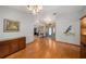 Open foyer with hardwood floors, neutral paint and decorative light fixture creating a welcoming entrance at 2838 Timber Knoll Dr, Valrico, FL 33596