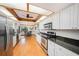 Bright kitchen featuring white cabinets, granite countertops, and stainless steel appliances at 2838 Timber Knoll Dr, Valrico, FL 33596