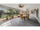 Enclosed lanai featuring a ceiling fan and glass table, offering an ideal space for outdoor dining and entertainment at 2838 Timber Knoll Dr, Valrico, FL 33596