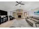 Spacious living room featuring a brick fireplace, wood laminate flooring, and comfortable seating at 2838 Timber Knoll Dr, Valrico, FL 33596