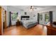Spacious main bedroom featuring hardwood floors, a ceiling fan, and access to the outdoors through French doors at 2838 Timber Knoll Dr, Valrico, FL 33596