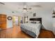 Comfortable main bedroom with hardwood floors, ceiling fan and a serene ambiance for relaxation at 2838 Timber Knoll Dr, Valrico, FL 33596