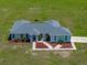 Stunning aerial shot of a lovely home with charming landscaping and a spacious driveway at 30017 Johnston Rd, Dade City, FL 33523