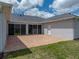 Back patio with brick flooring and string lights, attached to home via sliding glass doors at 30017 Johnston Rd, Dade City, FL 33523